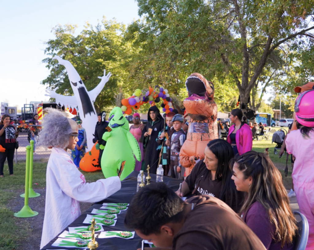 kids at a table in halloween costumes at pumpkin palooza